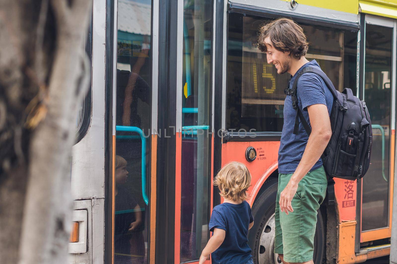 Father and son going to go by bus in Hong Kong by galitskaya