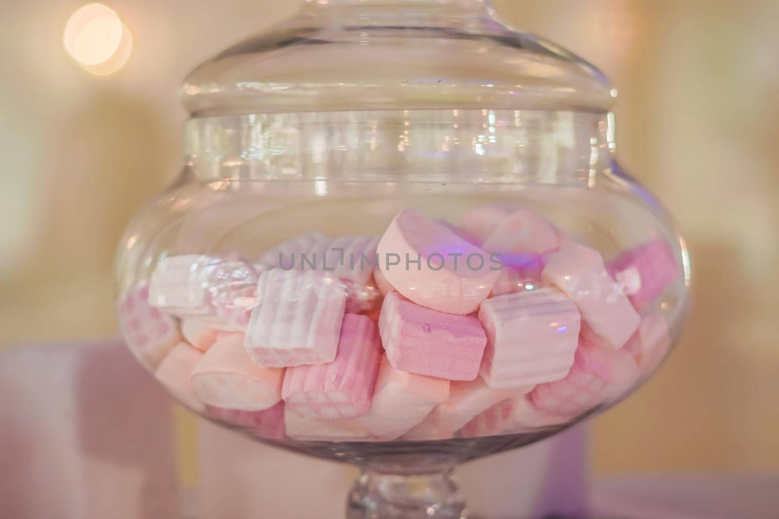 White and pink marshmallows in a jar.