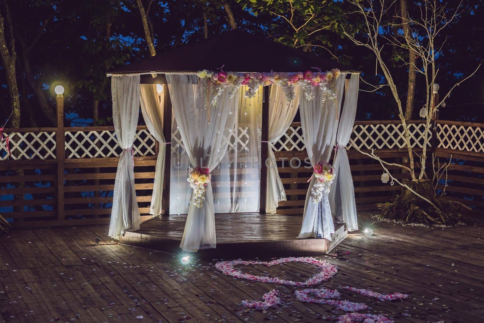 Night wedding ceremony. Decorations for wedding ceremony arch and lamps in the night forest.