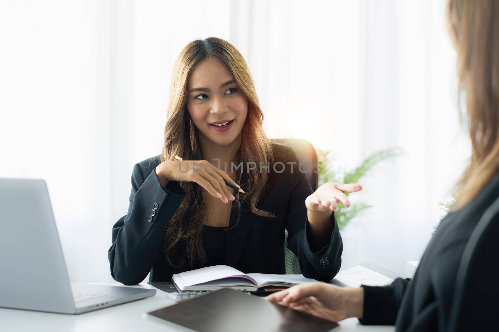 Women candidate at job interview explaining about her profile to business manager. hiring and employment concept. by itchaznong