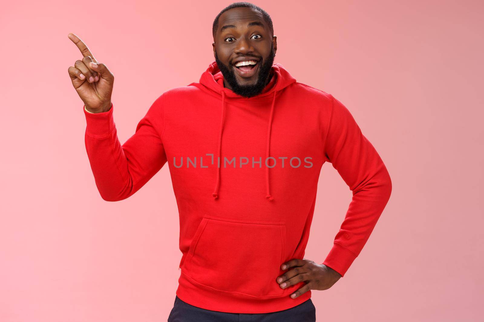 Enthusiastic happy good-looking young black guy beard pointing upper left corner smiling approval like curious about interesting item sale ask question excited impressed, standing pink background by Benzoix