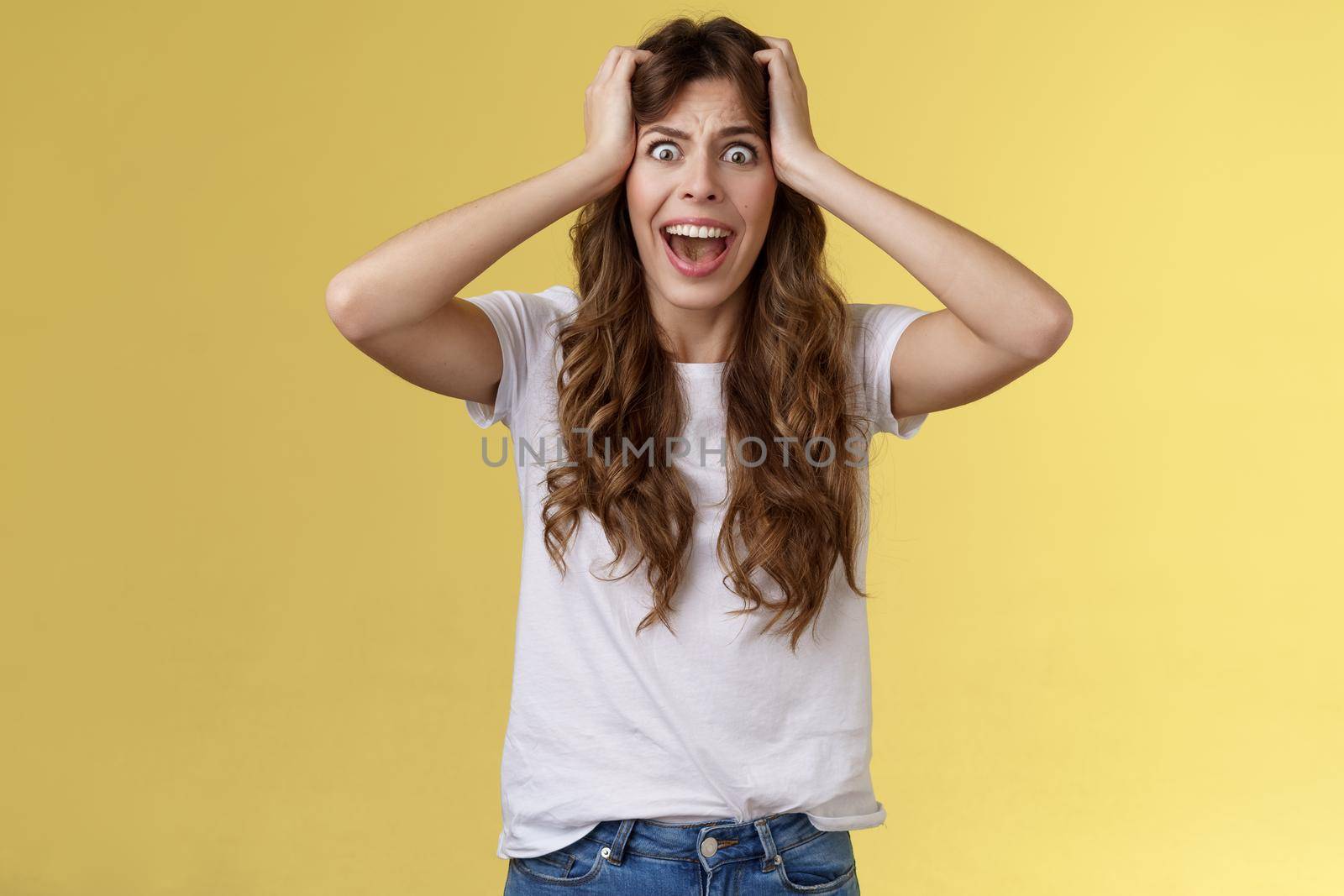 Girl screaming panic. Troubled distressed anxious woman see huge mess terrified feel sorrow shouting shocked grab head hopeless problem terrible situation yelling shook stunned yellow background by Benzoix