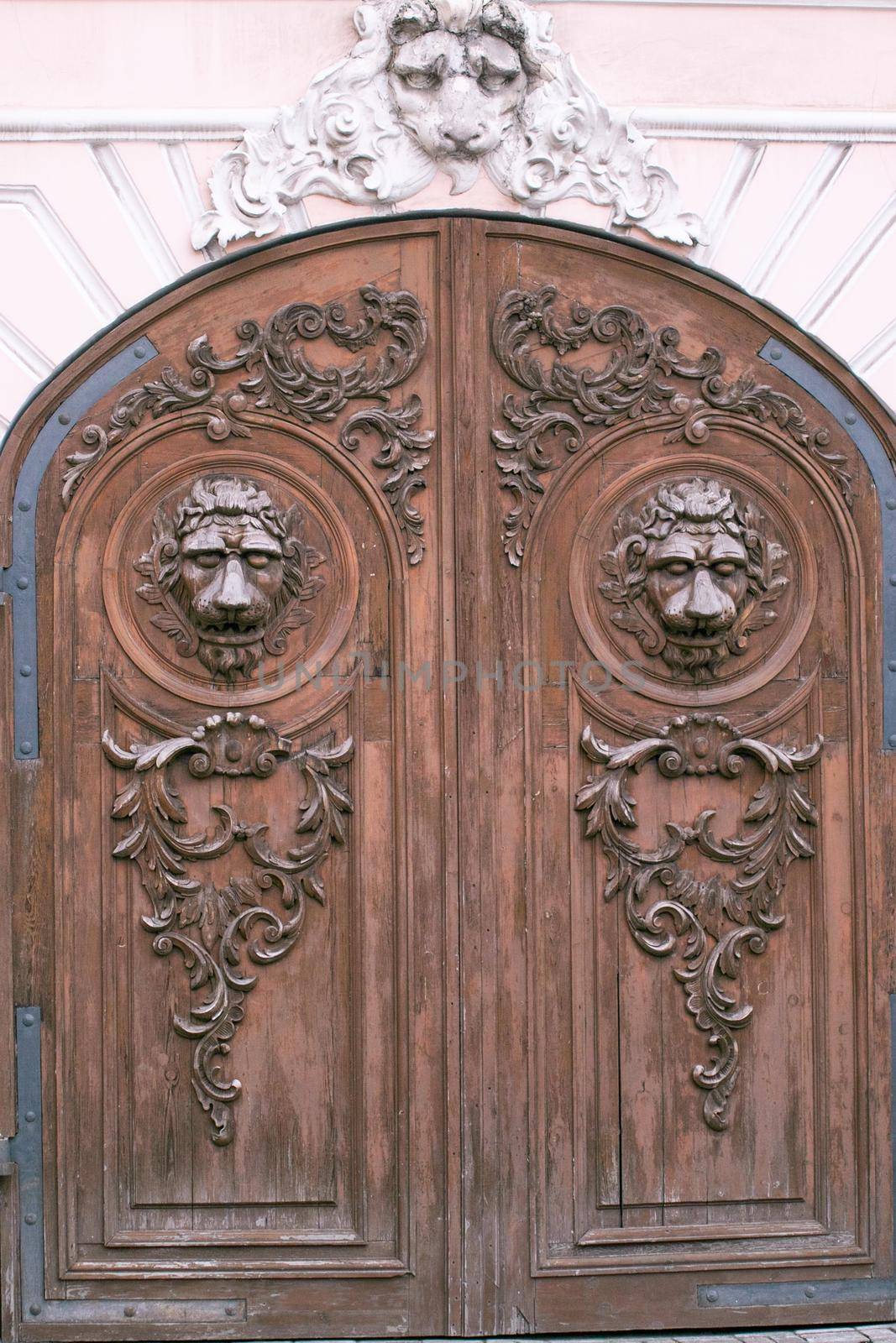 rusty metal antique lion's head doorknocker on a gray stone wall. High quality photo