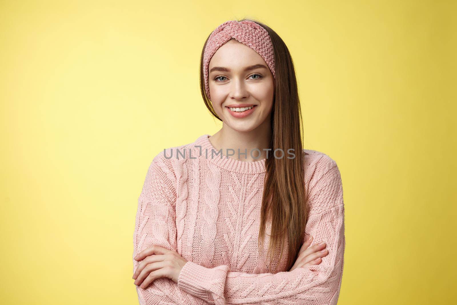 Waist-up shot of confident creative joyful cute european female model in knitted pink sweater, headband, cross arms self-assured, satisfied, smiling pleased and motivated, looking delighted by Benzoix