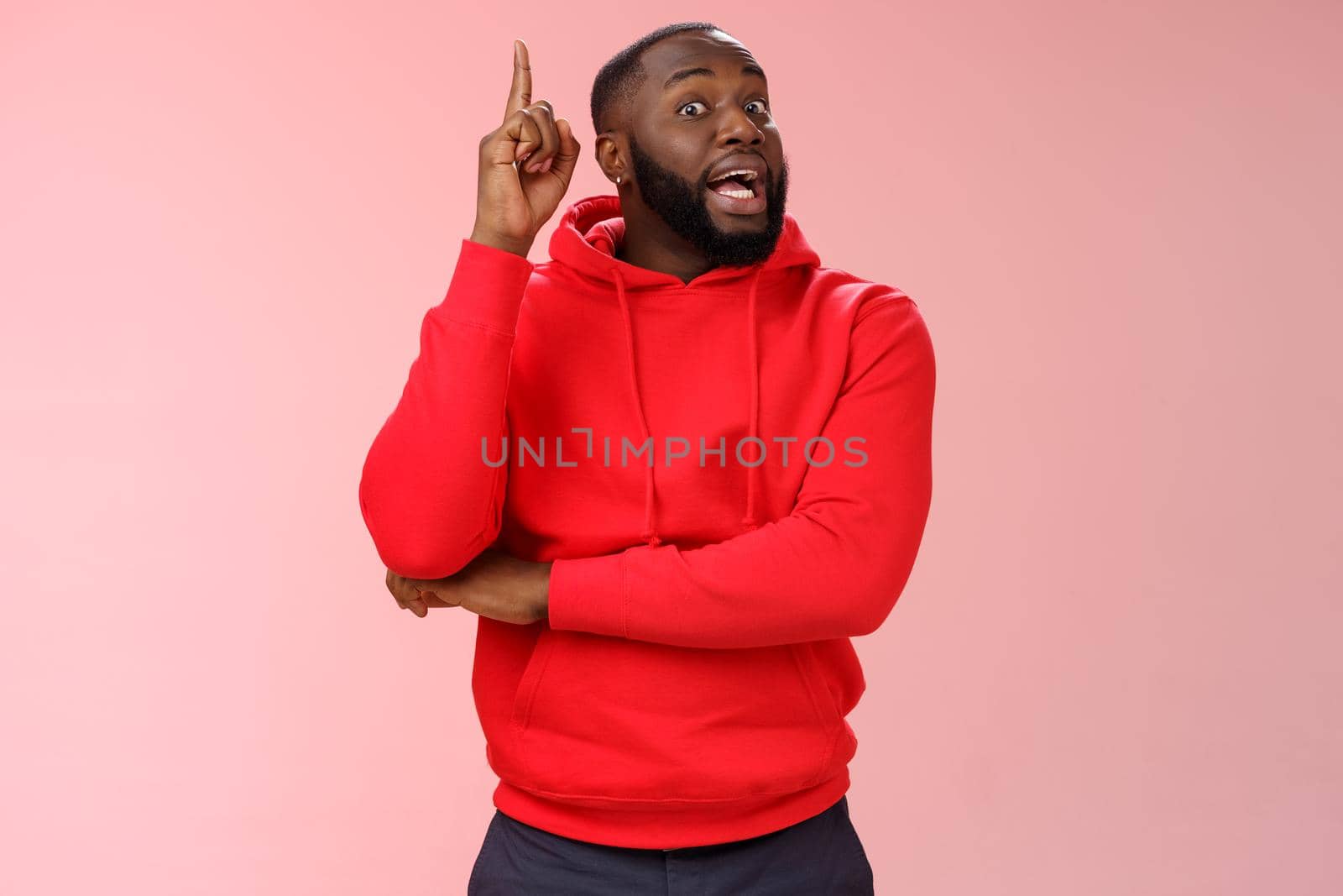 Got idea. Portrait excited african-american bearded guy inhale air have speech reise index finger eureka gesture wanna add word, have excellent plan sharing thoughts, standing pink background.