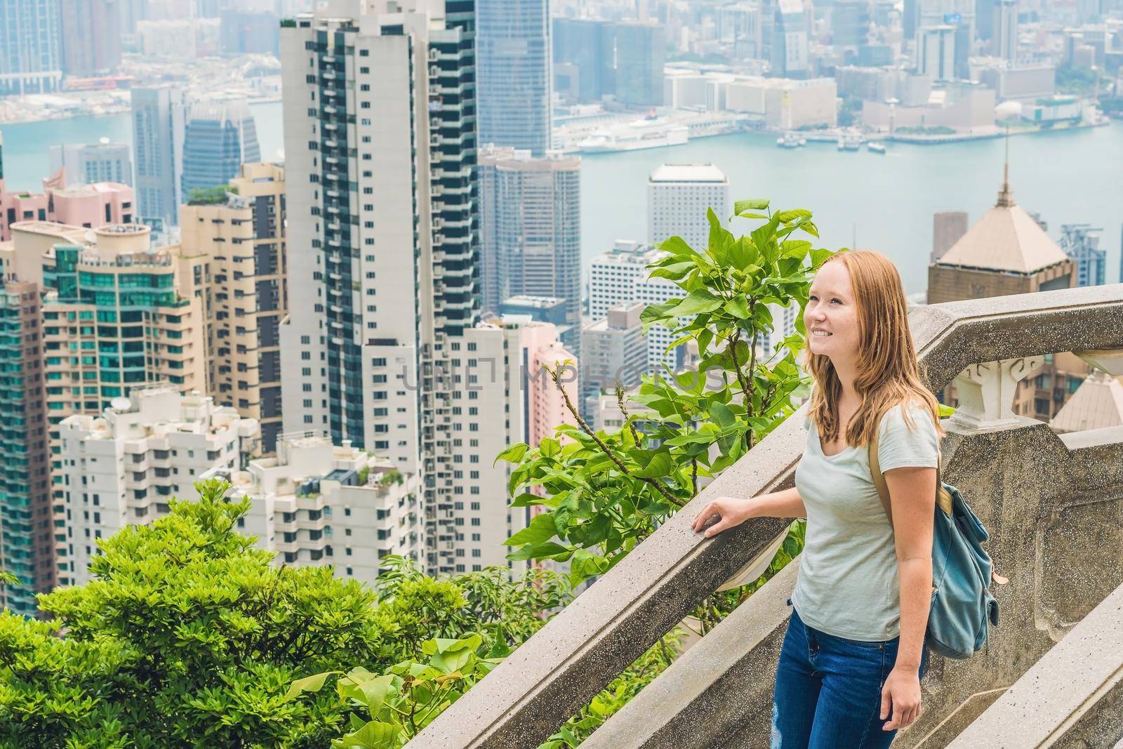 Young woman traveler at the peak of Victoria against the backdrop of Hong Kong by galitskaya