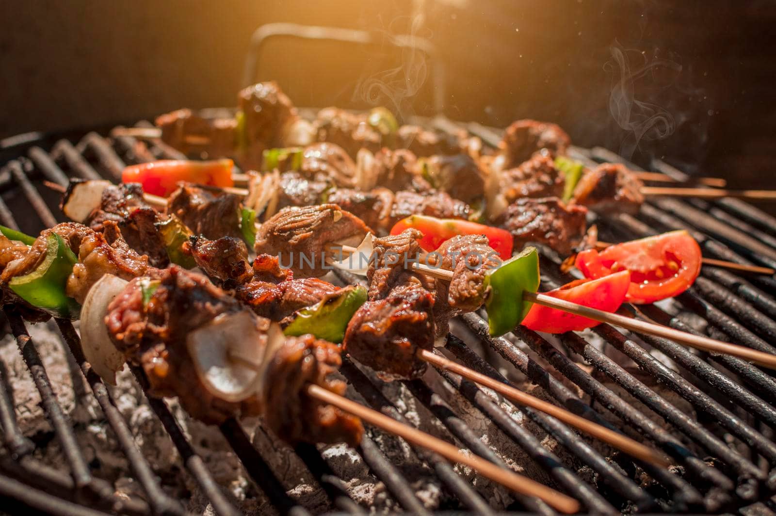 Roast beef skewers on a grill, Roast beef skewers grilling on a grill, Roast beef concept by isaiphoto