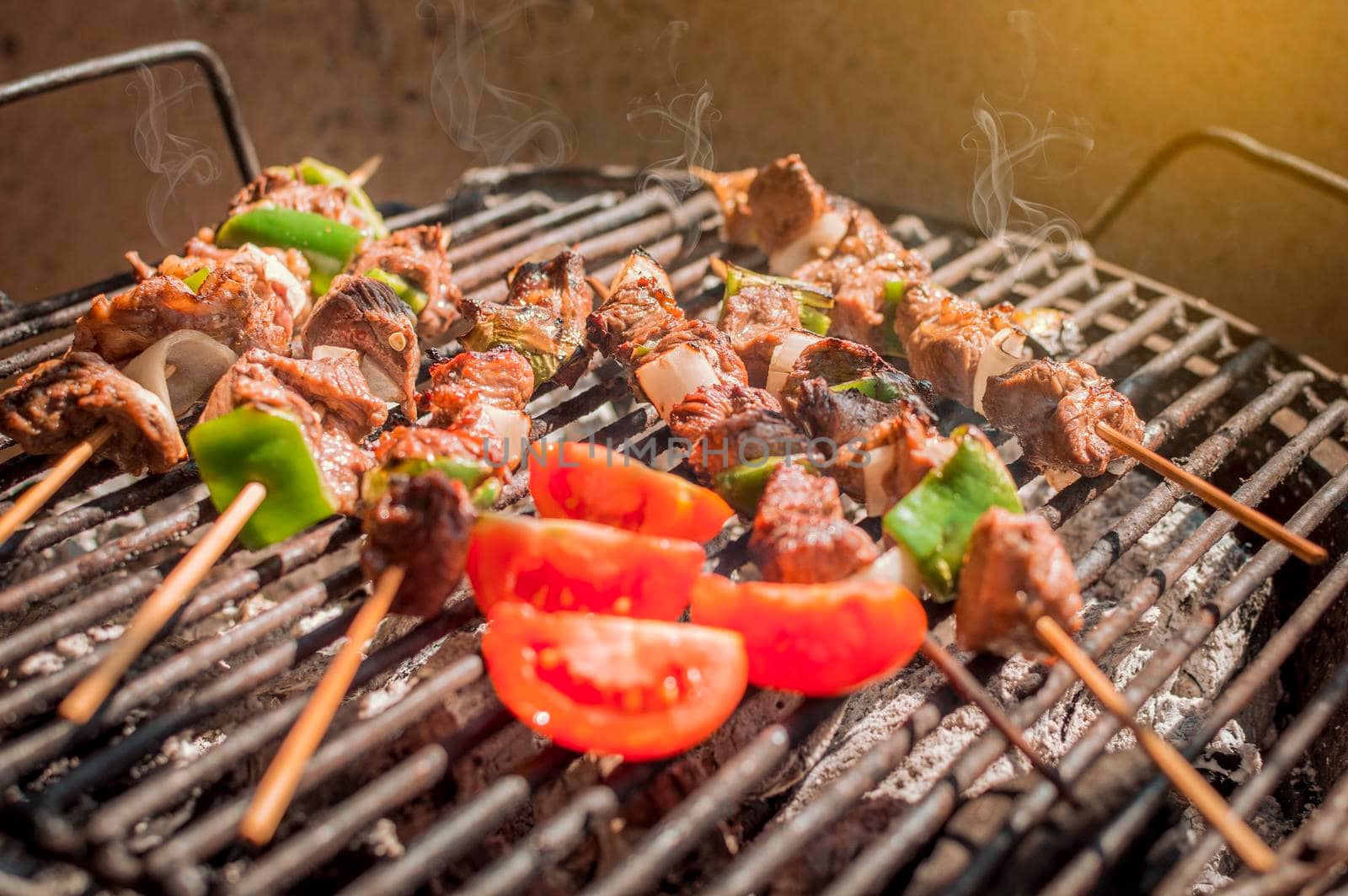 Roast beef skewers on a grill, Roast beef skewers grilling on a grill, Roast beef concept by isaiphoto