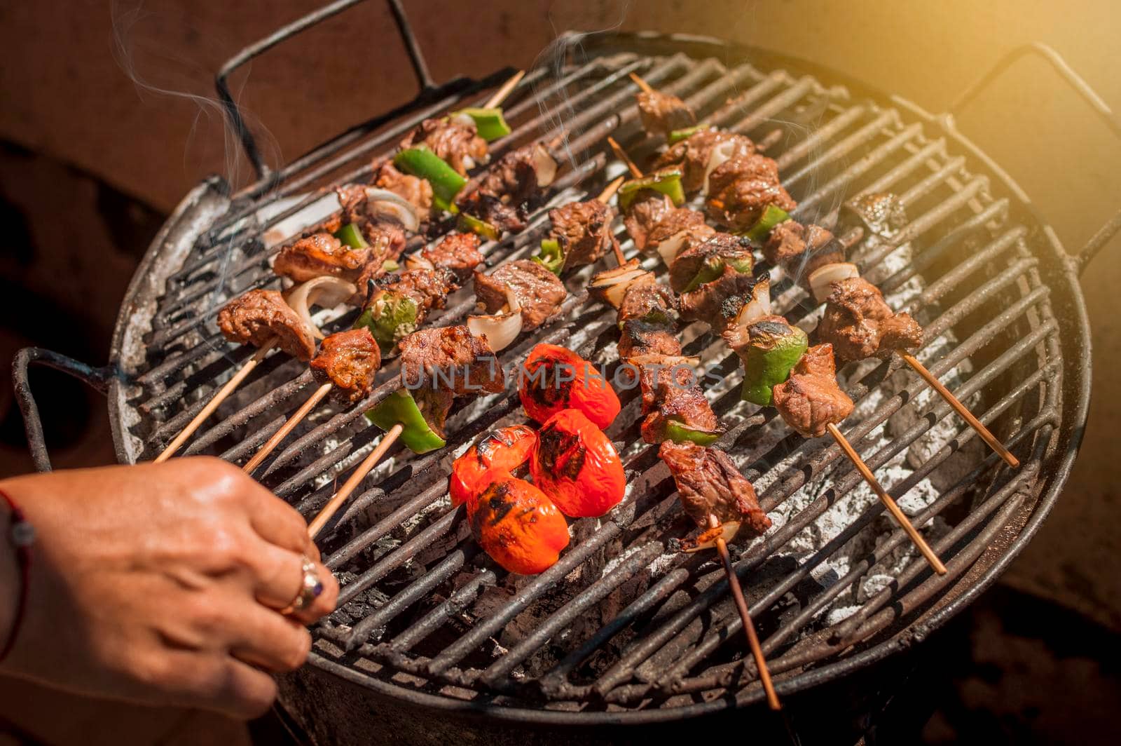 Roast beef skewers on a grill, Roast beef skewers grilling on a grill, Roast beef concept by isaiphoto