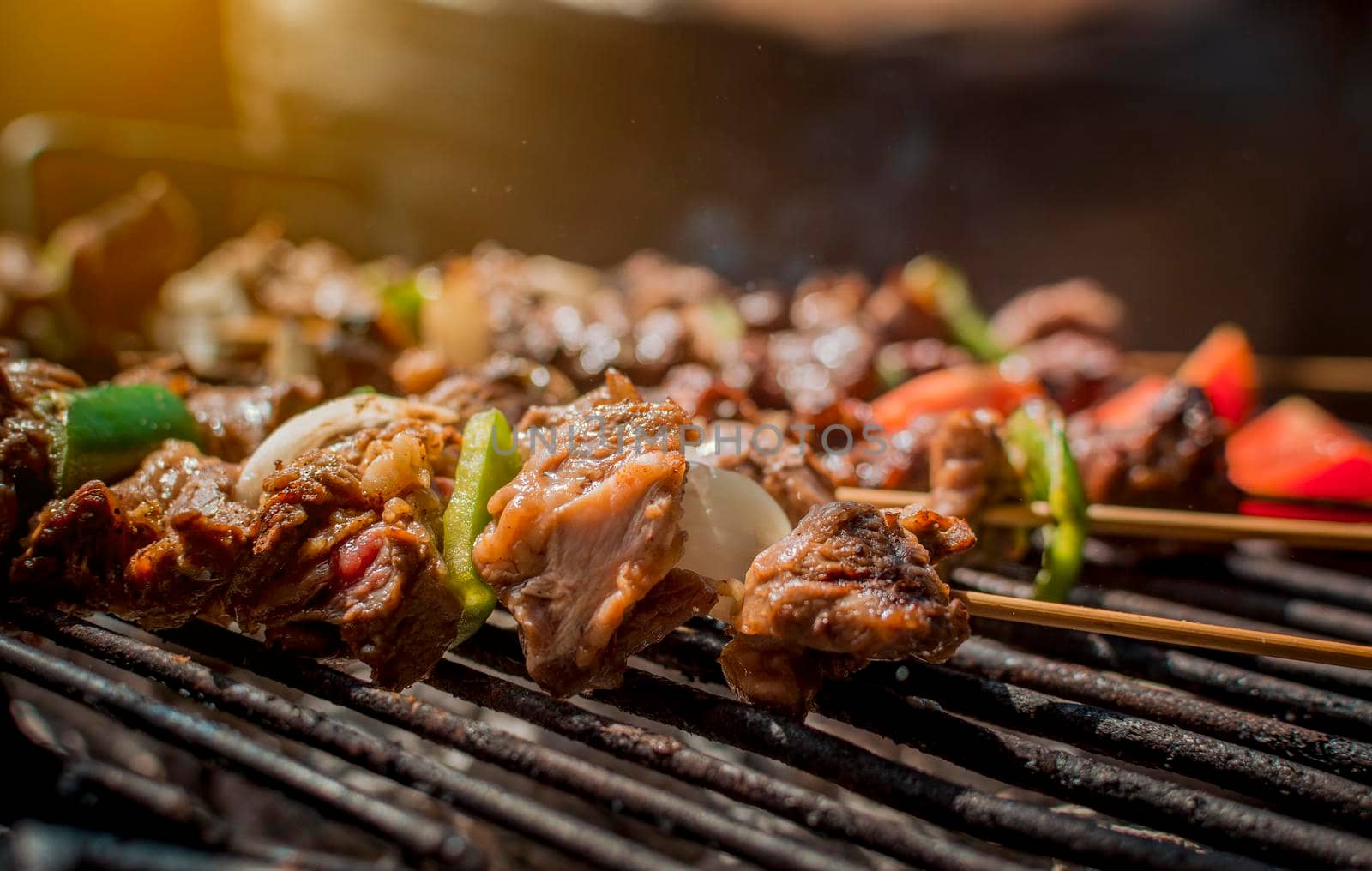 Roast beef skewers on a grill, Roast beef skewers grilling on a grill, Roast beef concept by isaiphoto