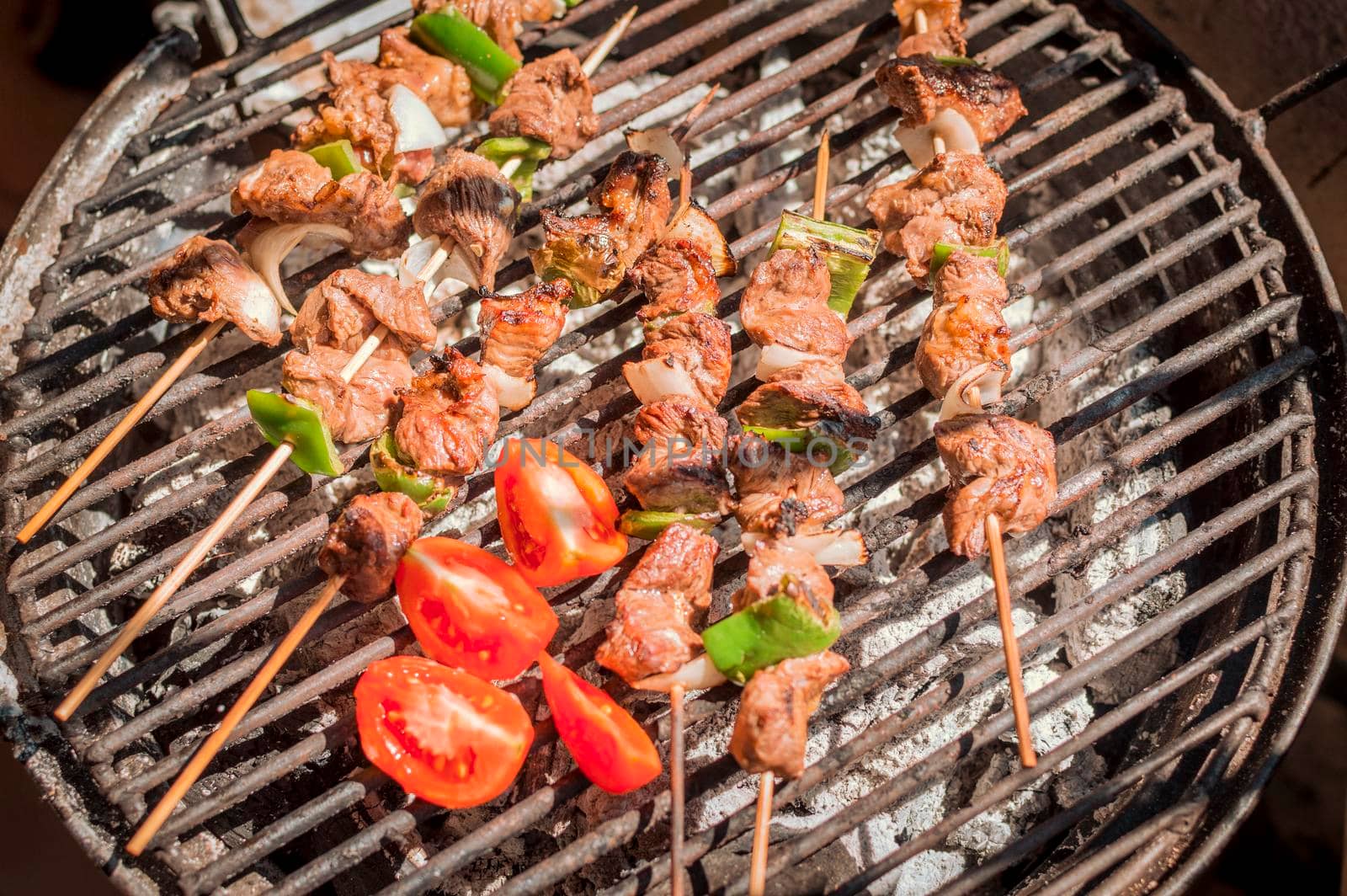 Roast beef skewers on a grill, Roast beef skewers grilling on a grill, Roast beef concept by isaiphoto