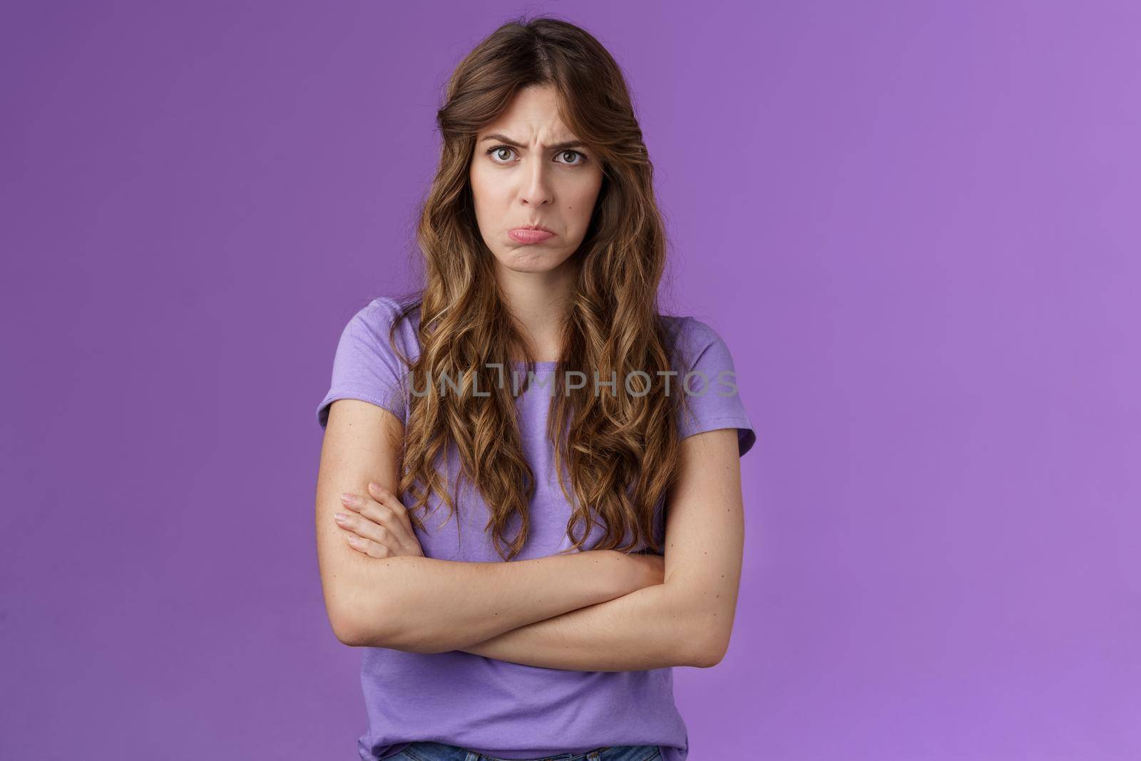 Offended silly timid cute girl sulking pouting lips frowning whining upset cross hands block pose insulted look moody camera disagree acting childish complaining unfair game purple background by Benzoix