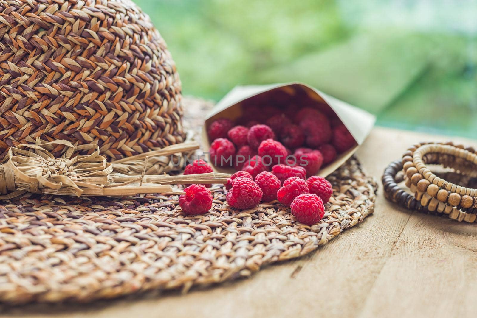 Summer holiday, vacation, relaxation concept. Raspberries, straw hat. Free text copy space. Summer vibes concept by galitskaya