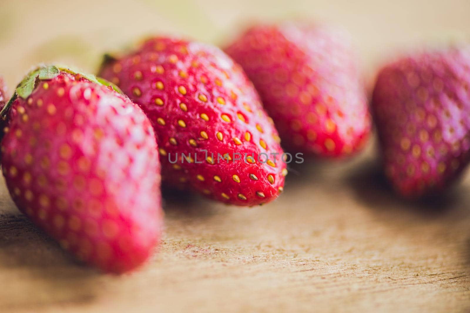 Fresh organic strawberry close-up on an old wooden background by galitskaya