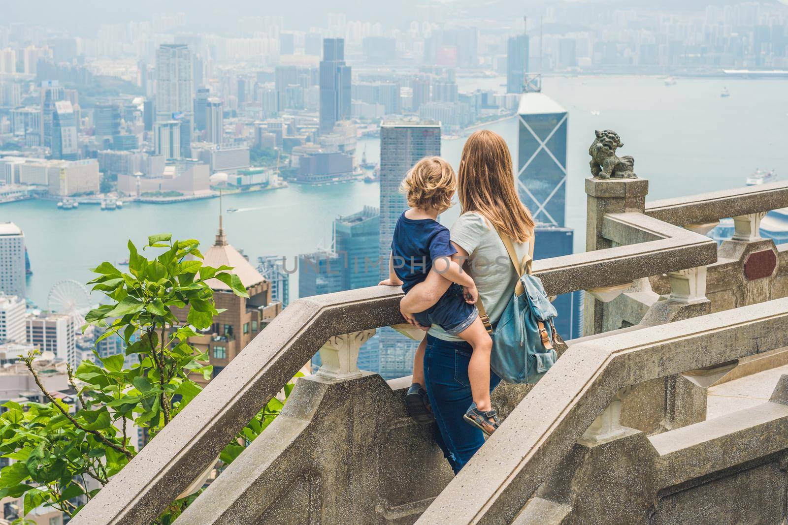 Mom and son travelers at the peak of Victoria against the backdrop of Hong Kong. Traveling with children concept by galitskaya