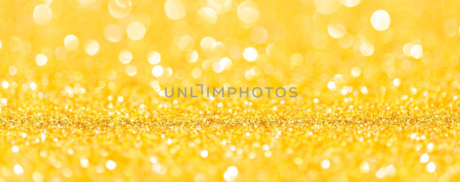 sparkles of yellow glitter abstract background. Copy space. Banner