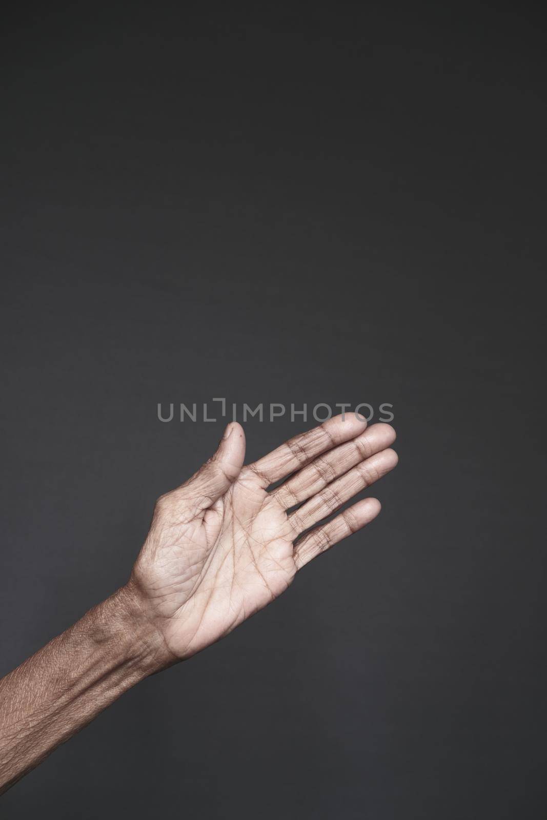 close up of hand of a elderly person isolated on black .