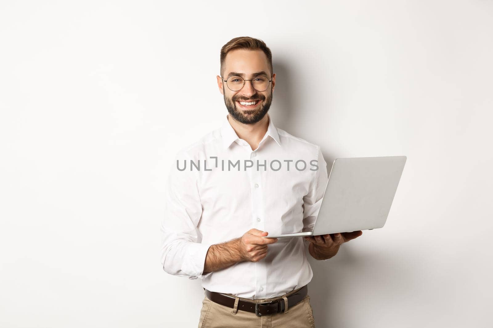 Business. Sucessful businessman working with laptop, using computer and smiling, standing over white background by Benzoix