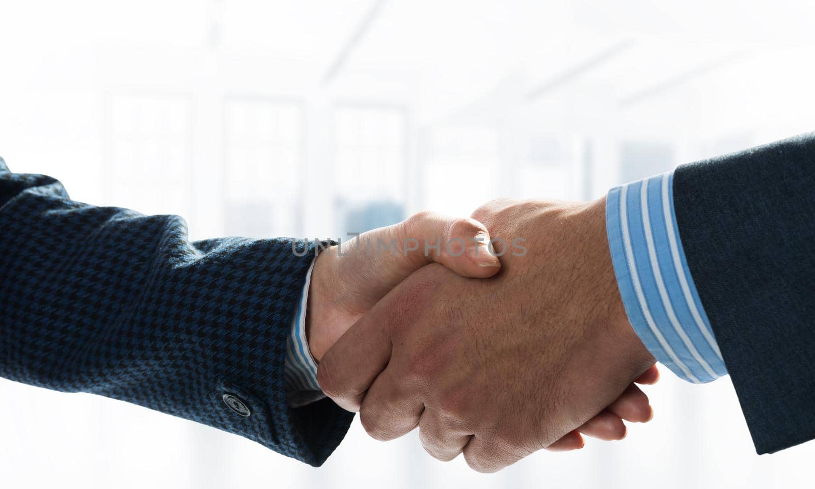 A close-up of a handshake. Making a deal between two businessmen