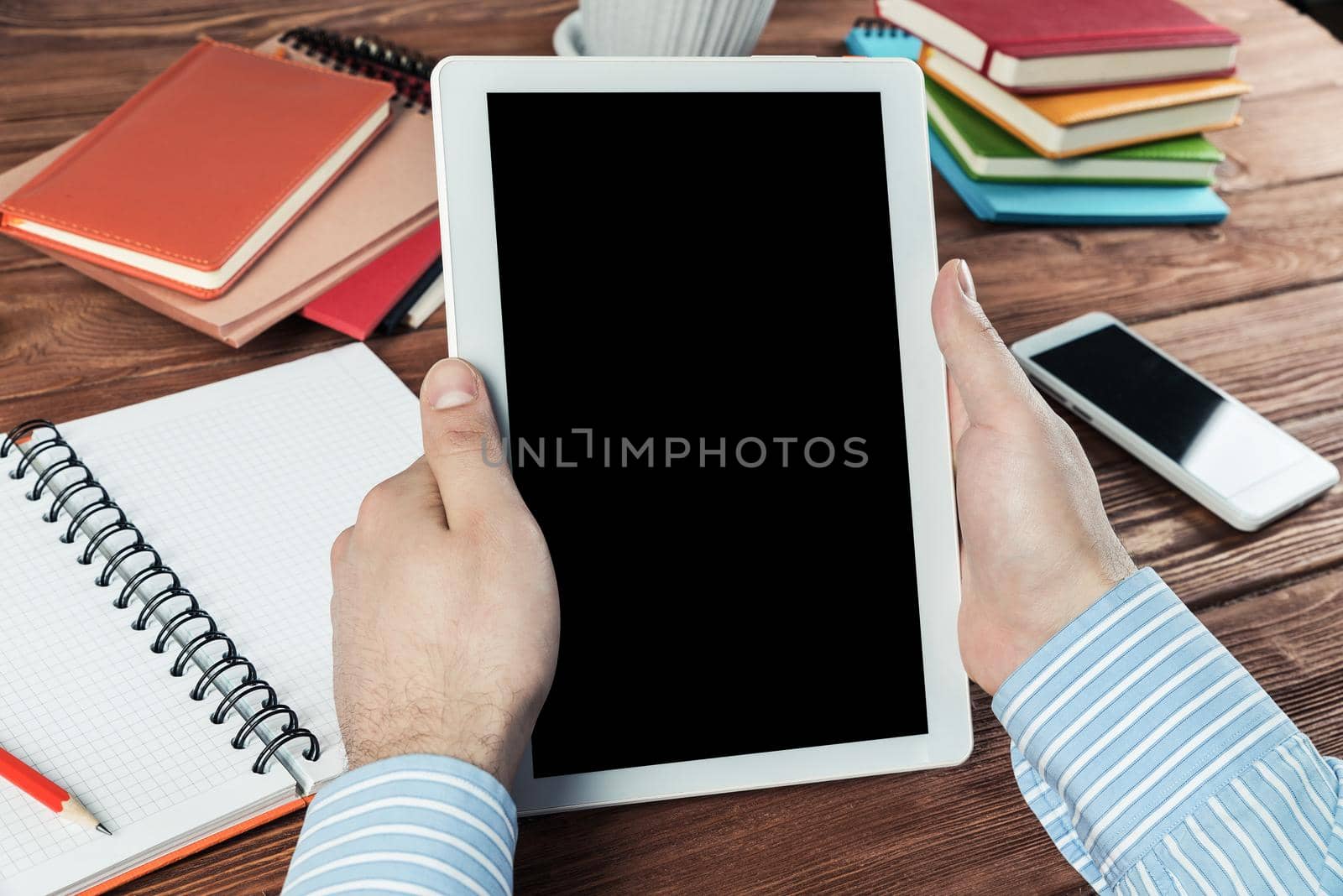 close-up of men's hands with a computer tablet. Businessman works in the office