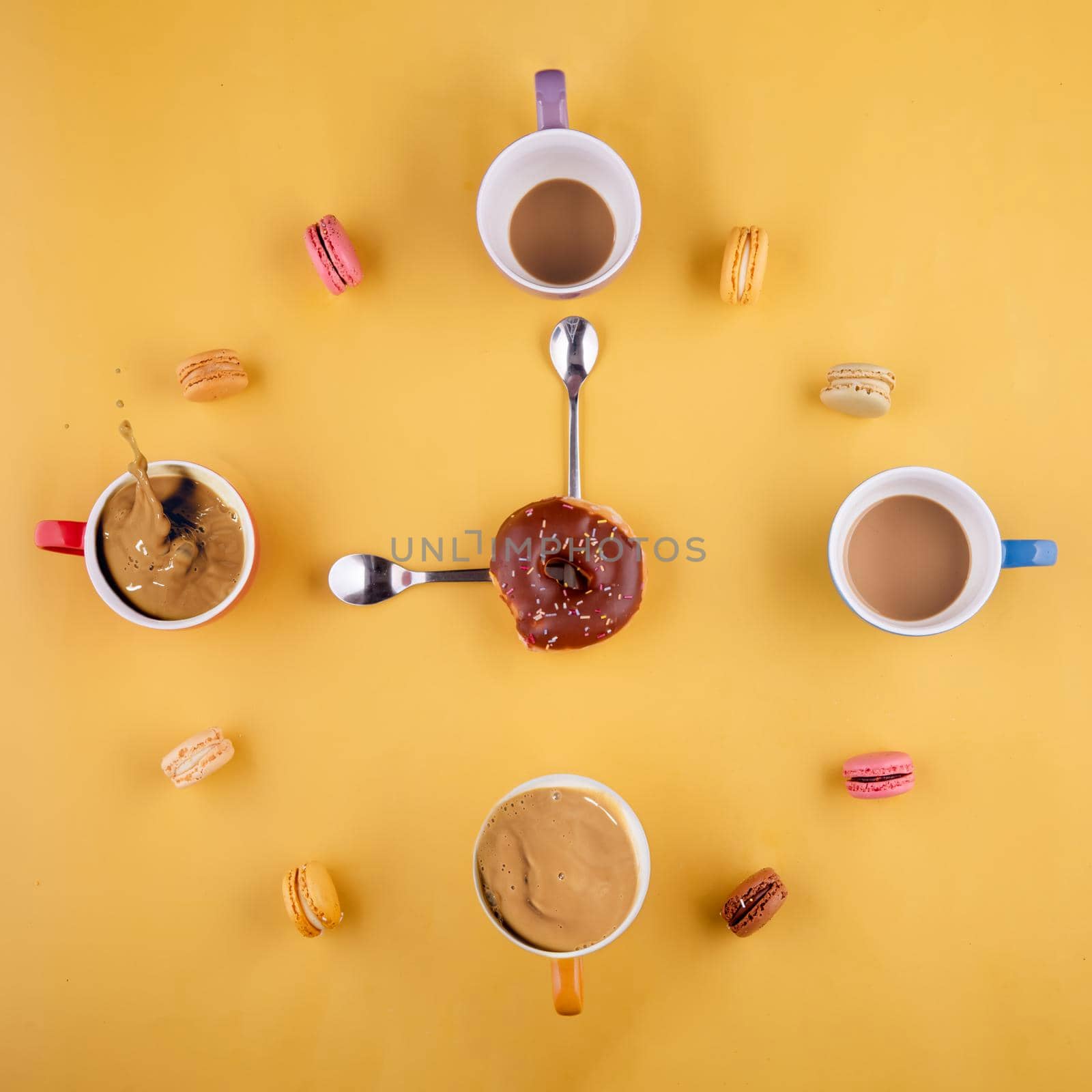 cups of coffee arranged like numbers in a clock, in the middle a donut and spoons like clock hands on yellow background