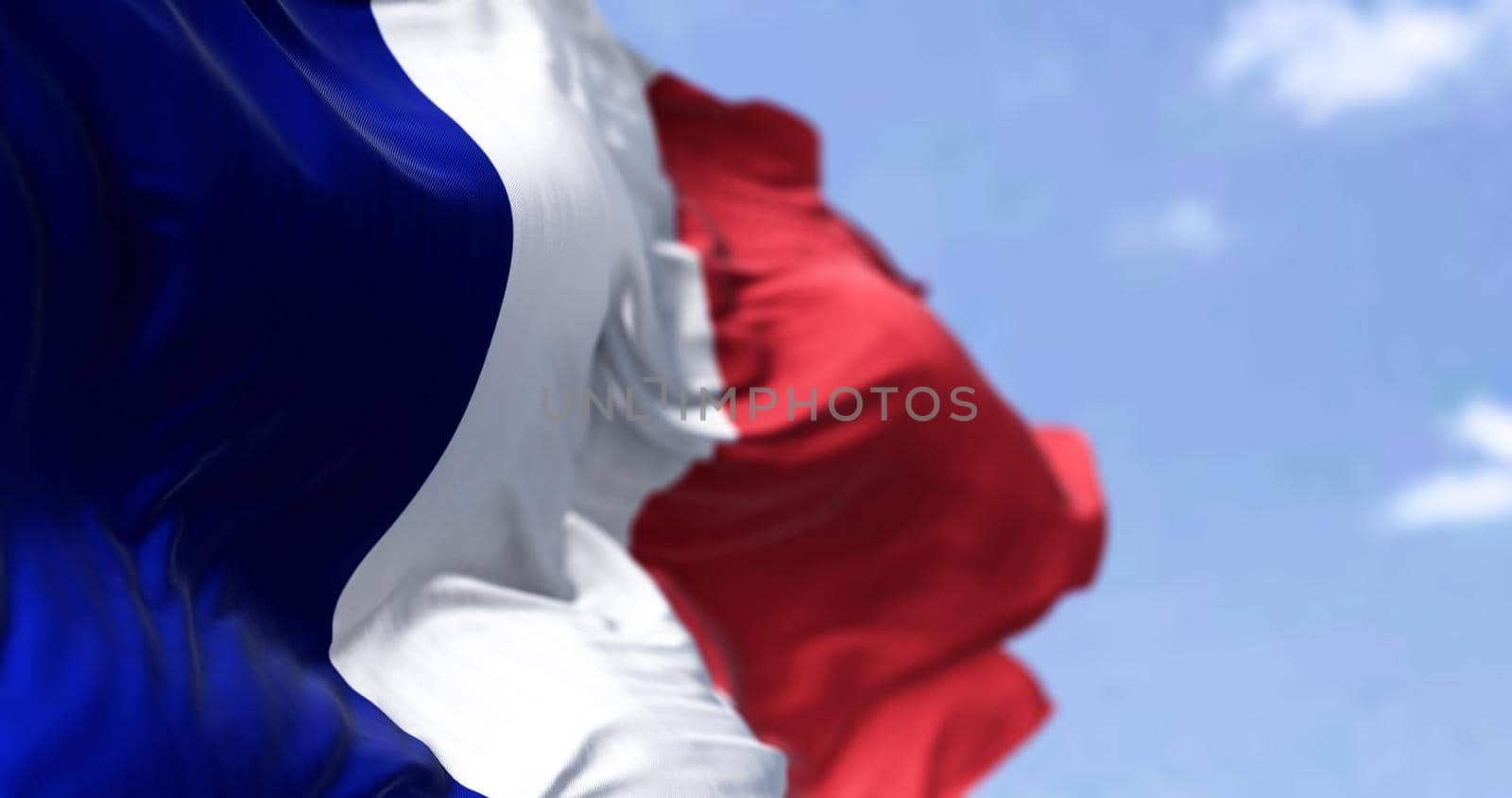 Detail of the national flag of France waving in the wind on a clear day by rarrarorro