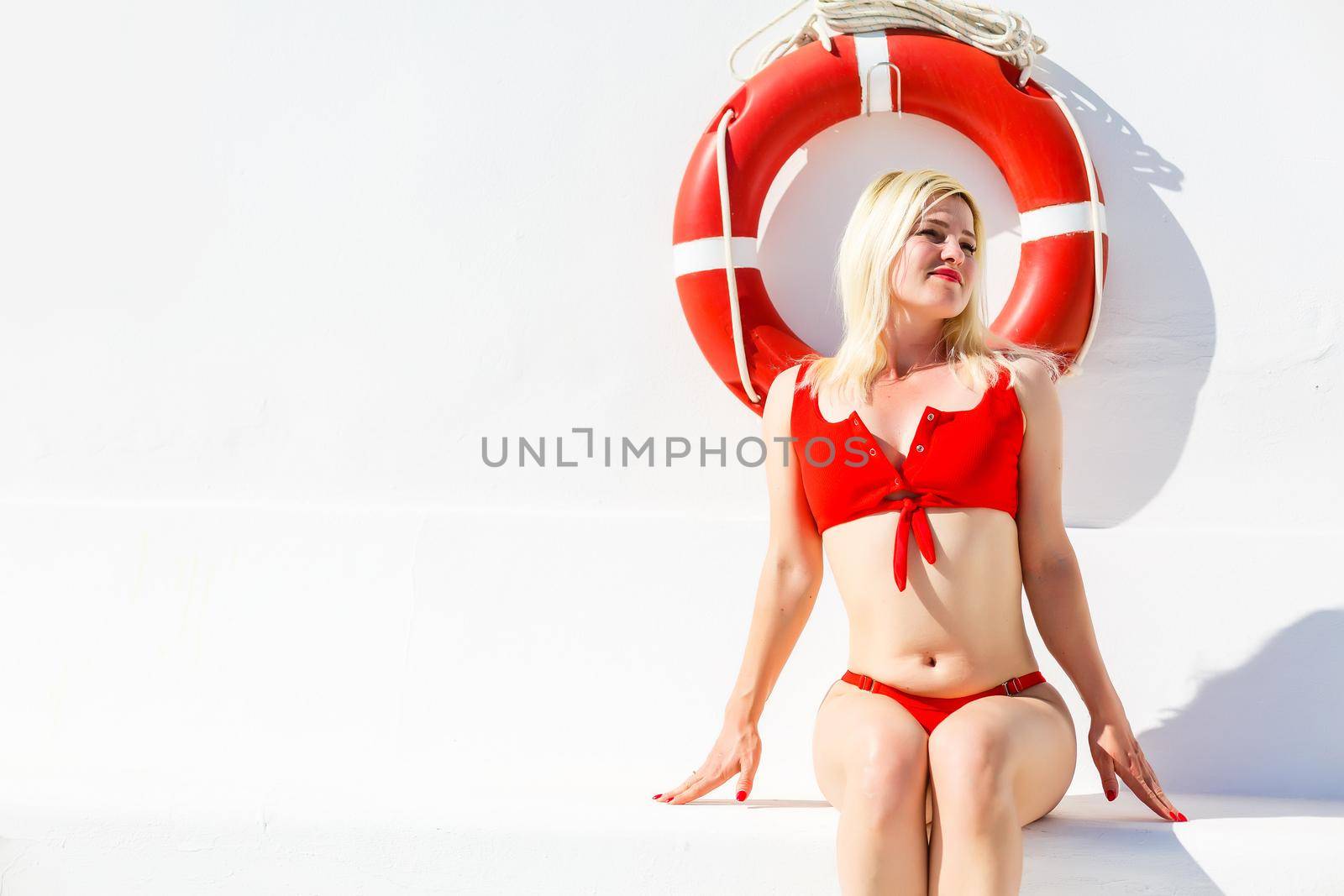 Woman posing with a lifebuoy. lifeguard concept