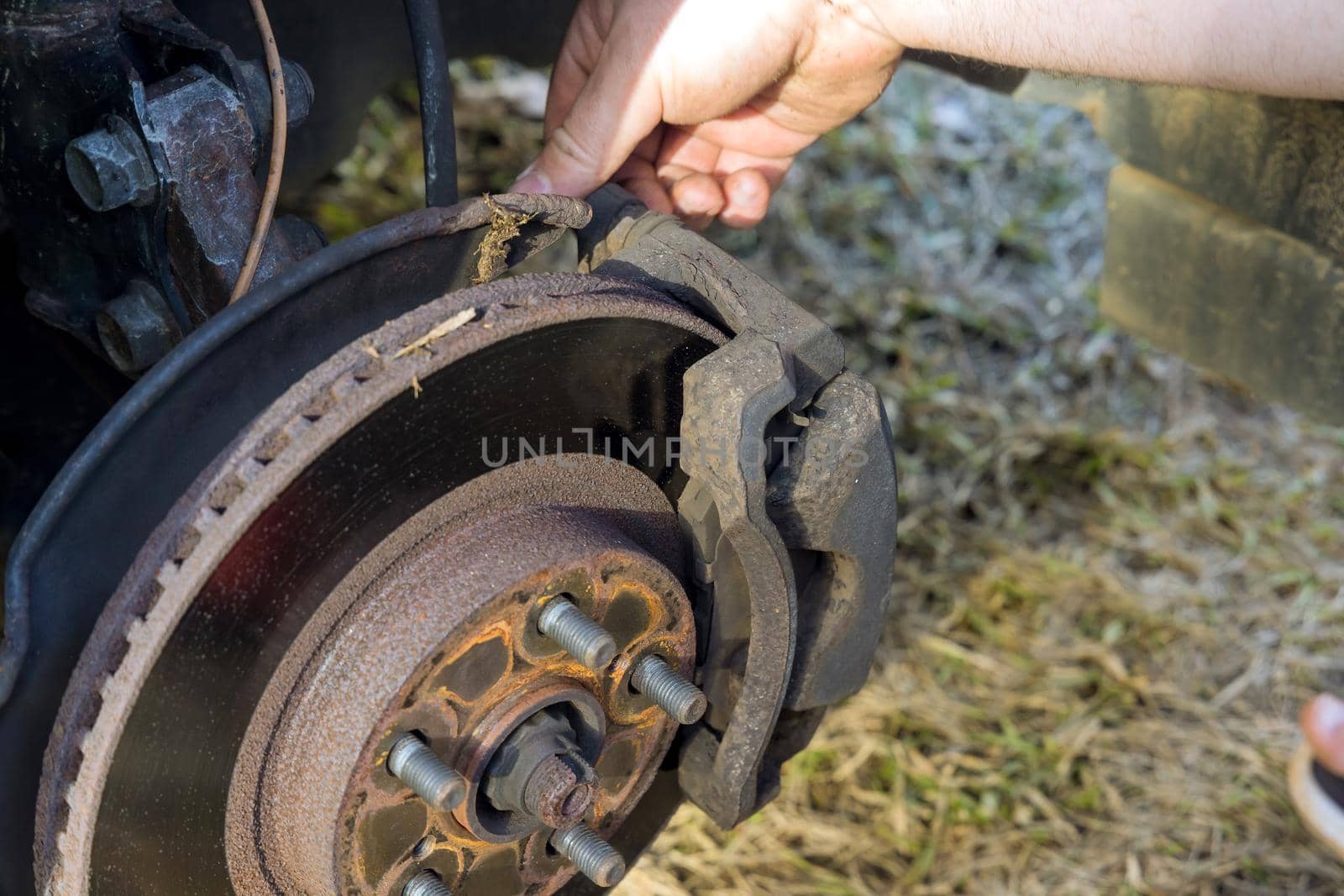 Car mechanic repair service change car disc brake pads from old brakes to new brakes