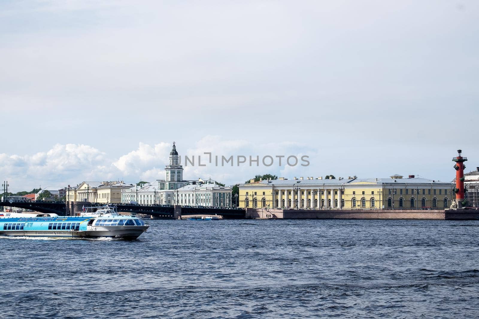 Saint-Petersburg, Russia. - August 11, 2021. View of historical buildings with museums, bridge and Neva river with sailing pleasure boat.