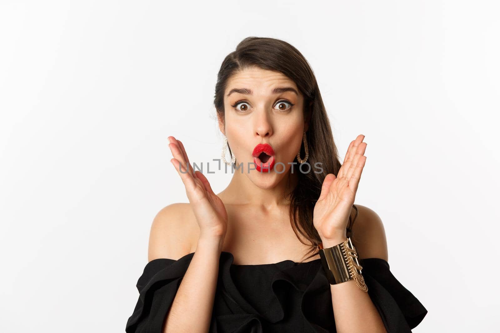 Fashion and beauty concept. Close-up of excited woman with makeup and red lipstick on, looking surprised and glad, standing over white background by Benzoix