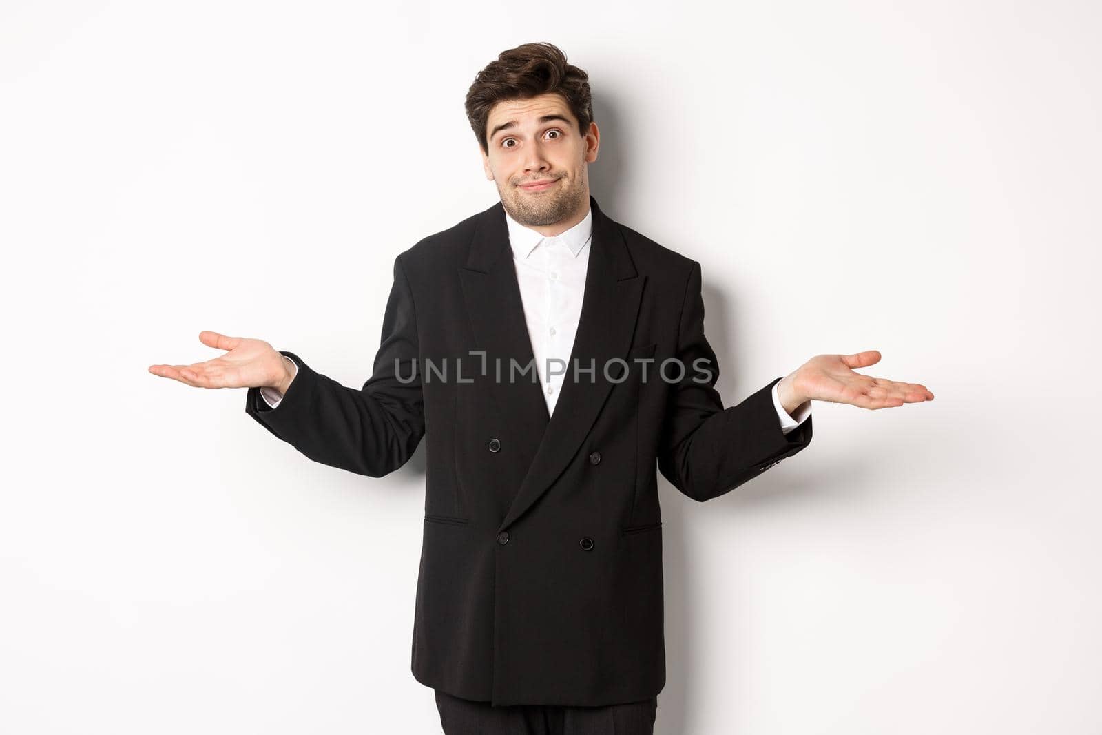 Image of handsome confused man in black suit, shrugging and looking clueless, dont know anything, standing over white background by Benzoix