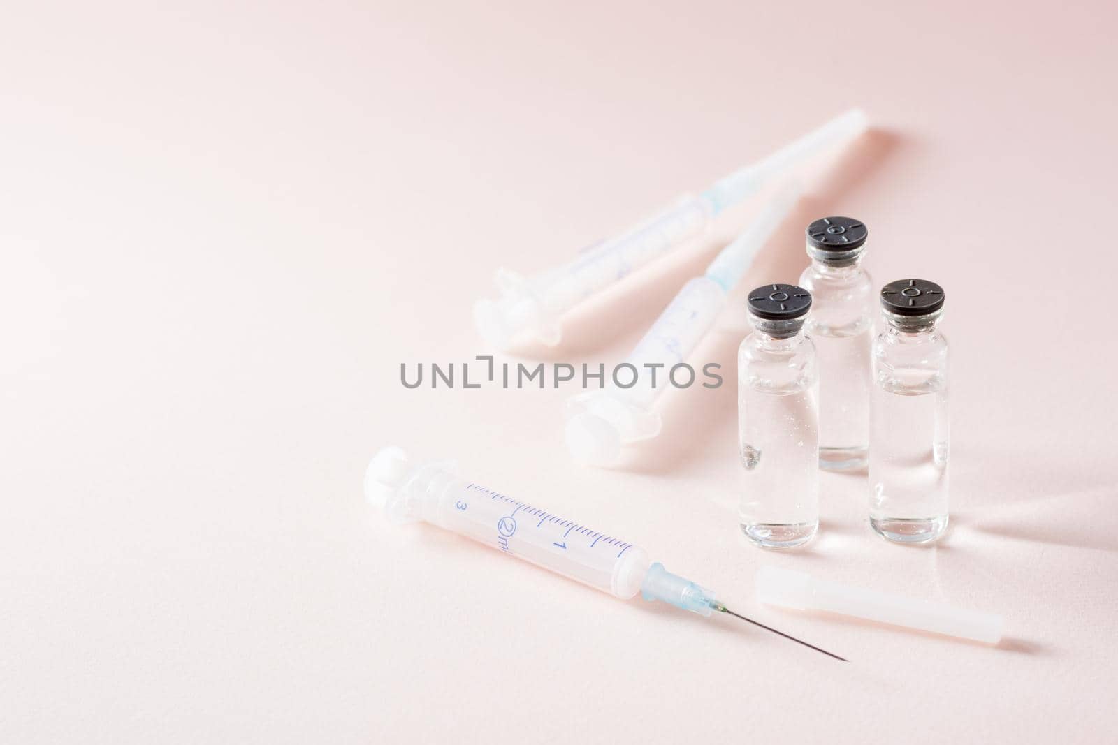 Vaccination and Immunization. Open syringe in front of glass vials with vaccine and clean syringes