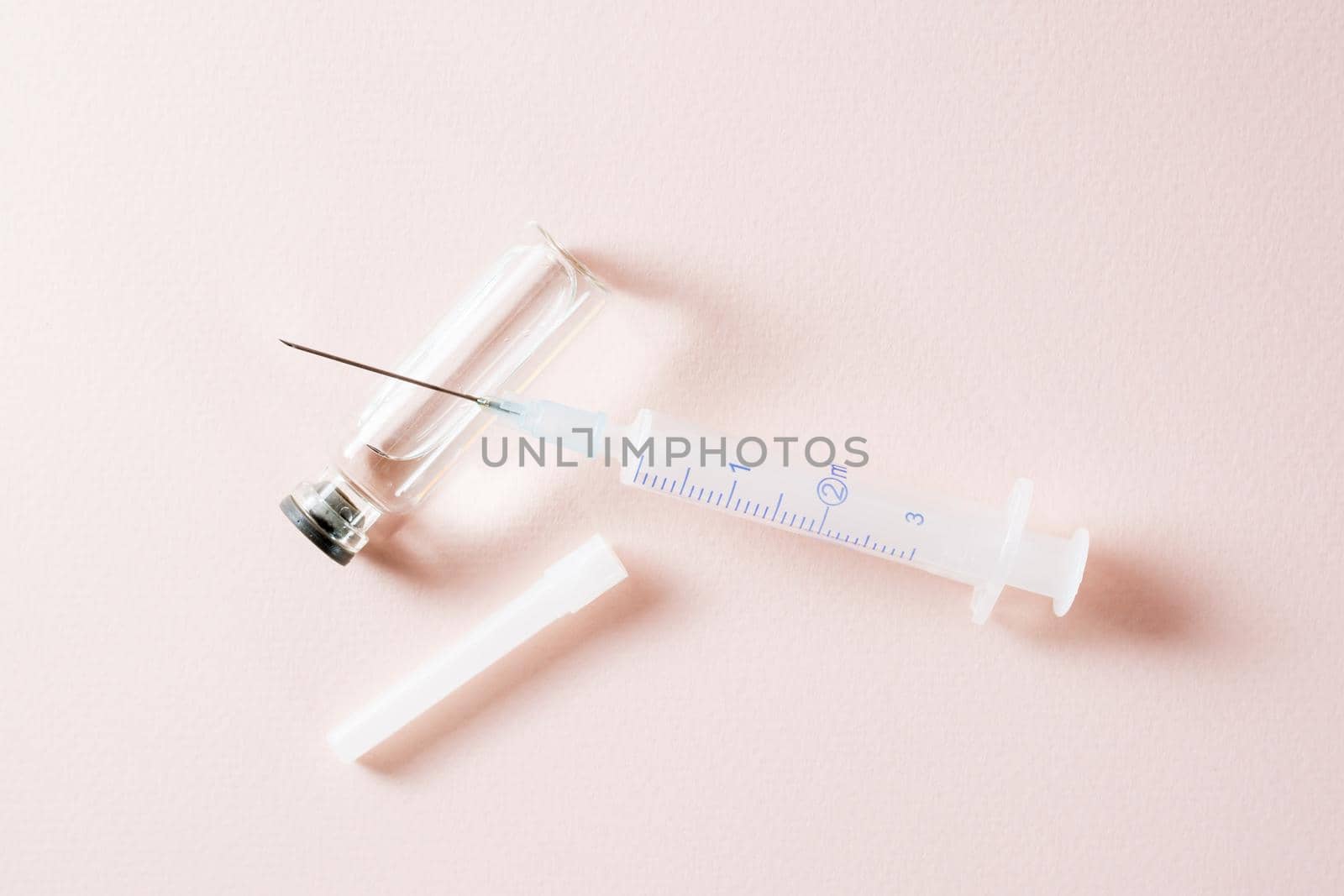 Vaccination and Immunization. Opened syringe on a glass vial with vaccine. Top view
