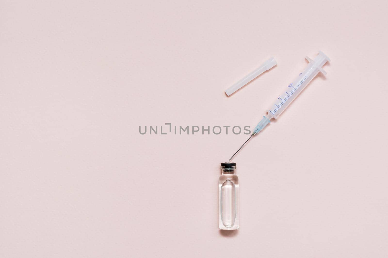 Vaccination and Immunization. Opened syringe over a glass vial with vaccine. Copy space