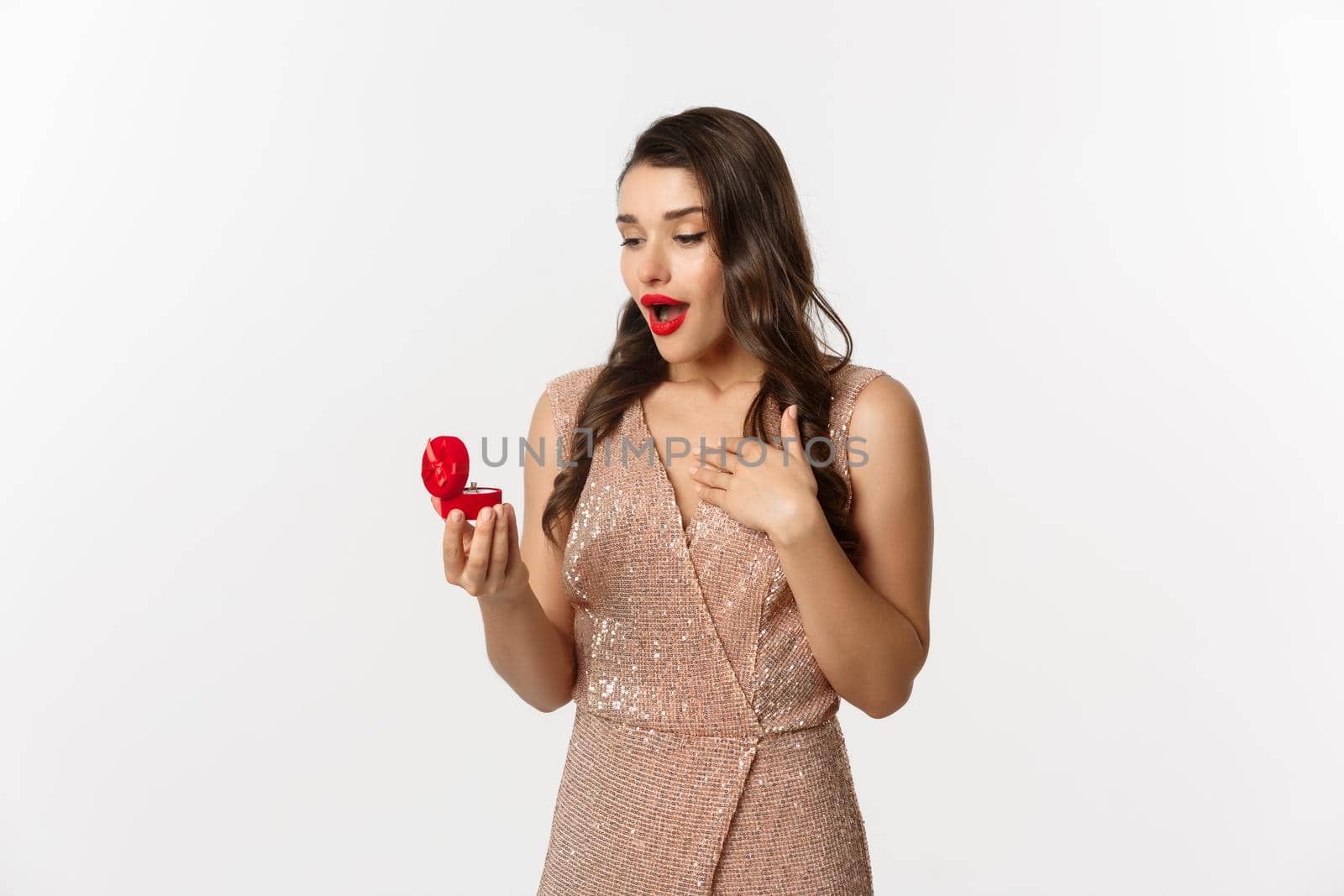 Image of surprised woman receiving marriage proposal, looking at engagement ring in red box and gasping amazed, concept of relationship.