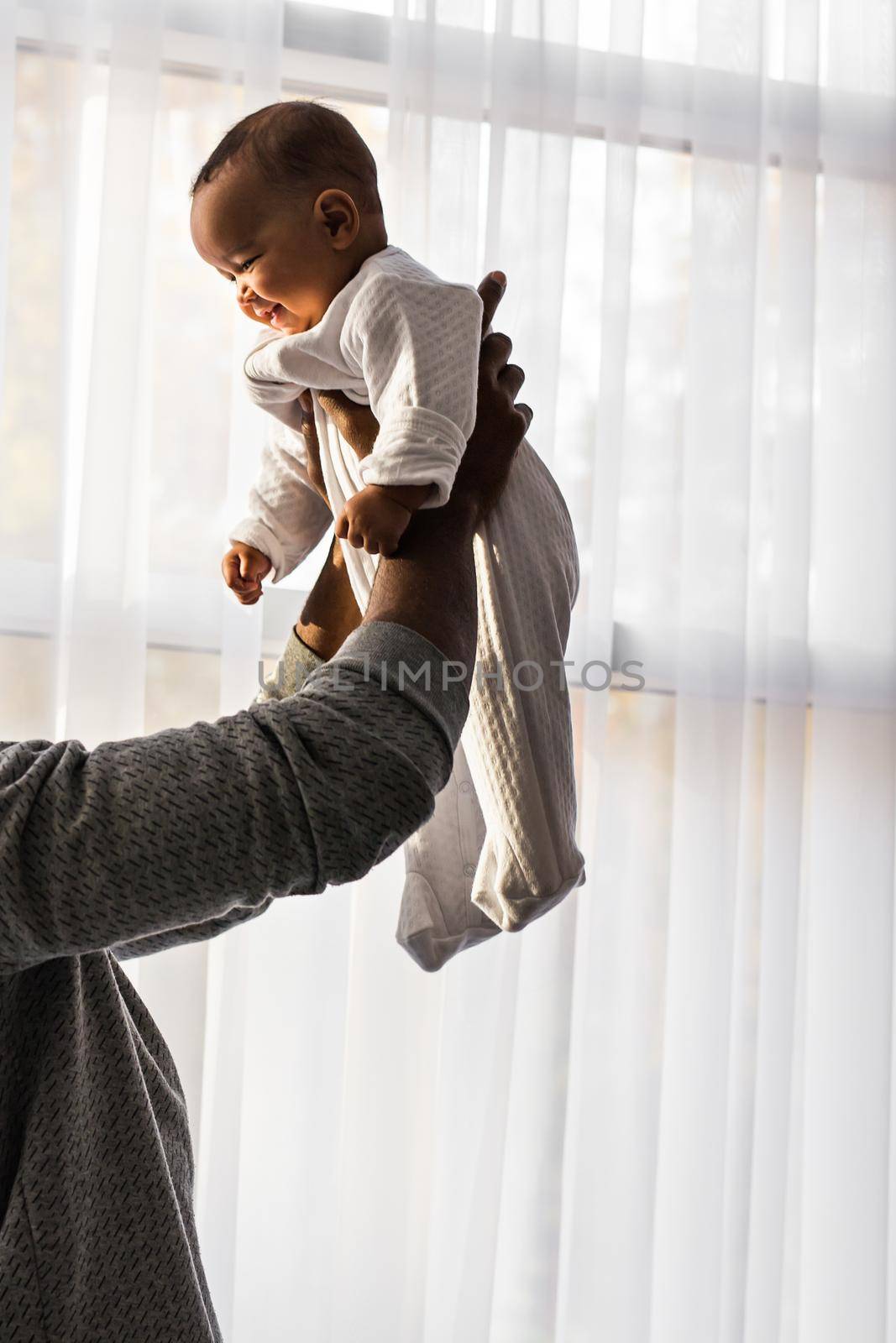 African American Father Playing With mixed race Baby Son.