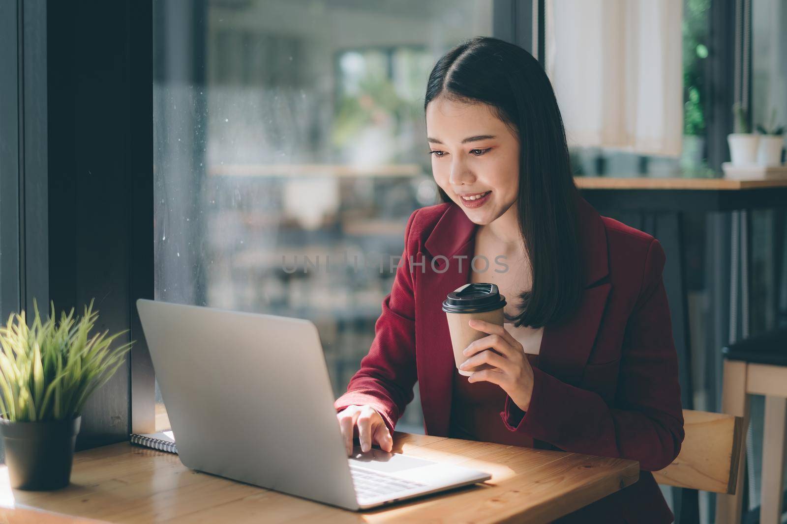 Business Finance and Accounting Concept. Business woman using security application on laptop to protect her money by itchaznong