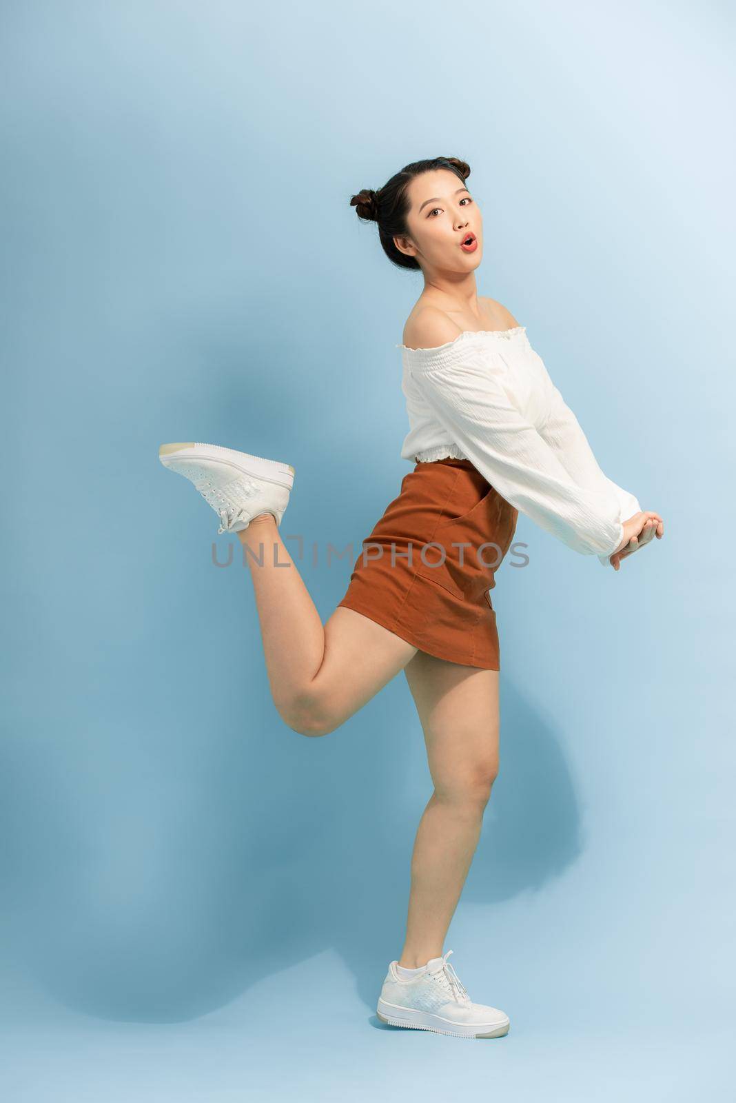 Full body photo of cheerful excited energetic girl jump enjoy spring free time holiday weekend isolated over bright color background by makidotvn