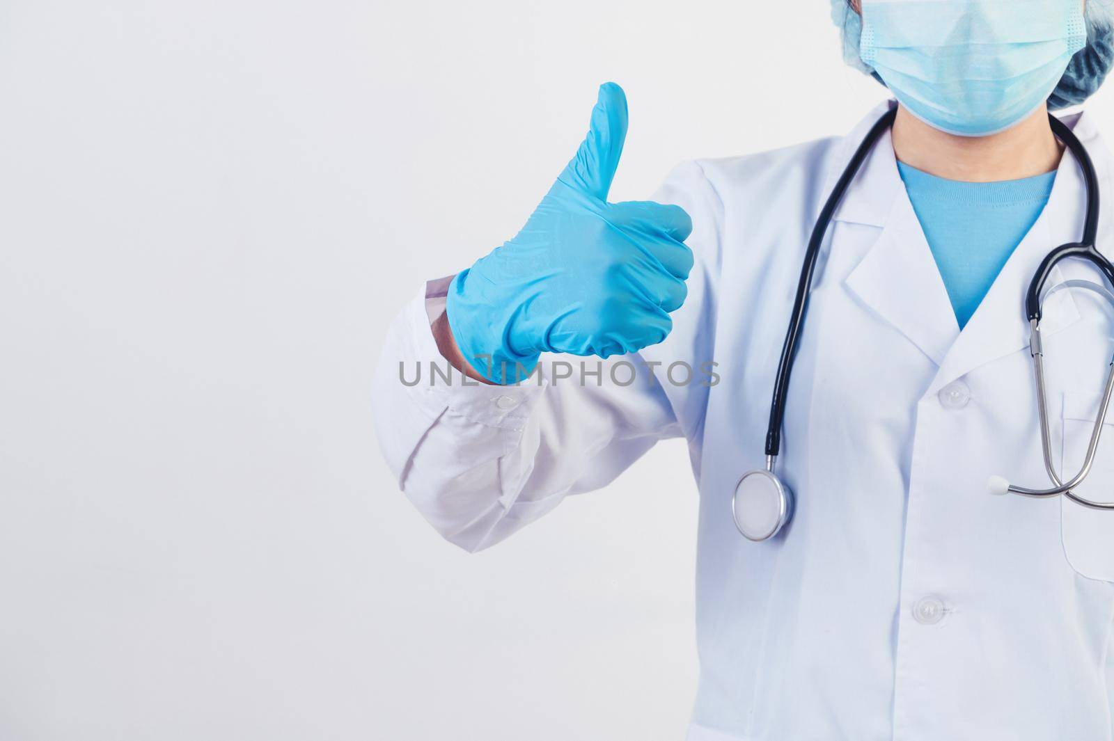 Closeup professional doctors give big thumbs up gesture on white background to patients who treated at hospital or clinic to assure will get well soon. Medical personnel and health people concept.