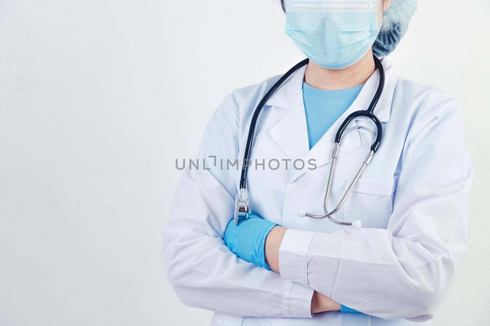 Professional doctor doing arms crossed gesture for build confidence in patients on white background. Medical personnel and Health people concept. Copy space by MiniStocker