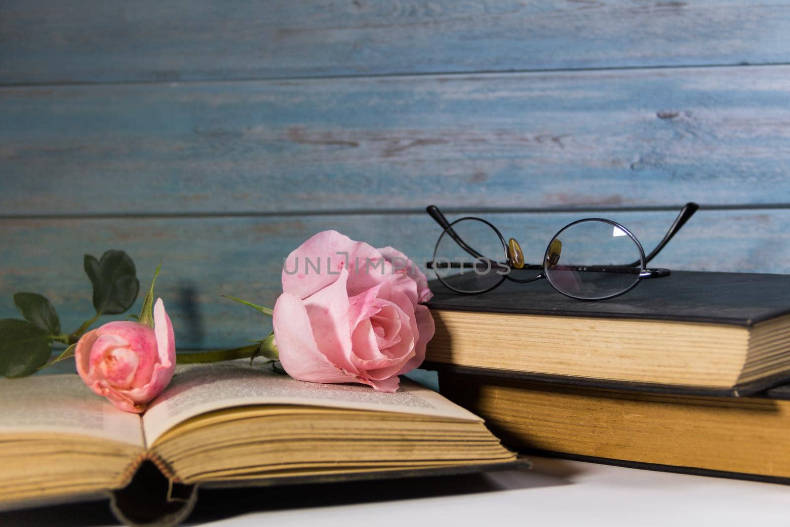 pink roses and books on rustic wood by GabrielaBertolini