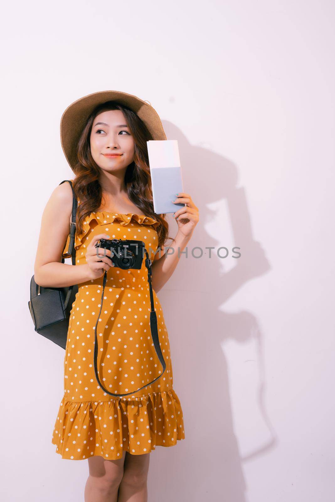 Beautiful travel woman with passport isolated on pastel backgroun