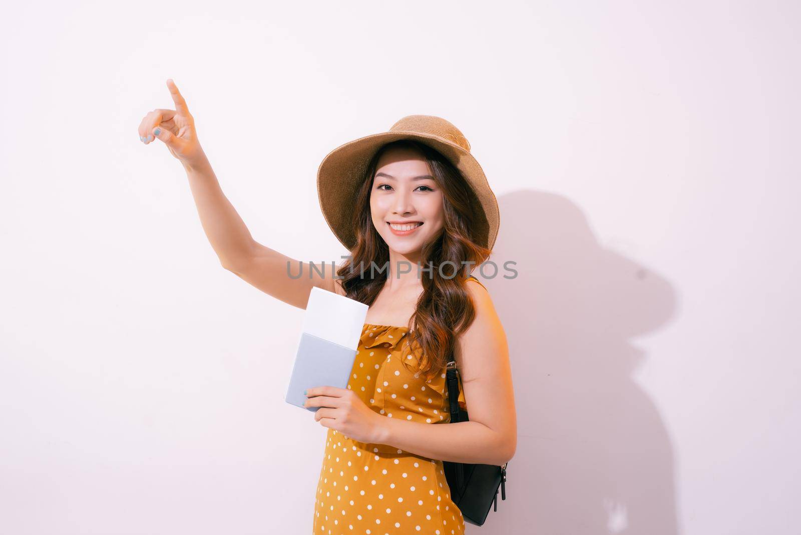 Travel concept portrait of smiling woman holding passport with ticket showing copy paste by makidotvn