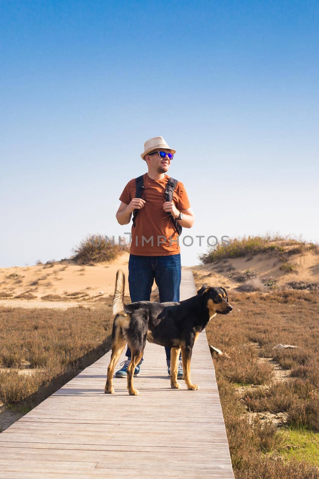 Outdoors lifestyle image of travelling man with cute dog. Tourism concept. by Satura86