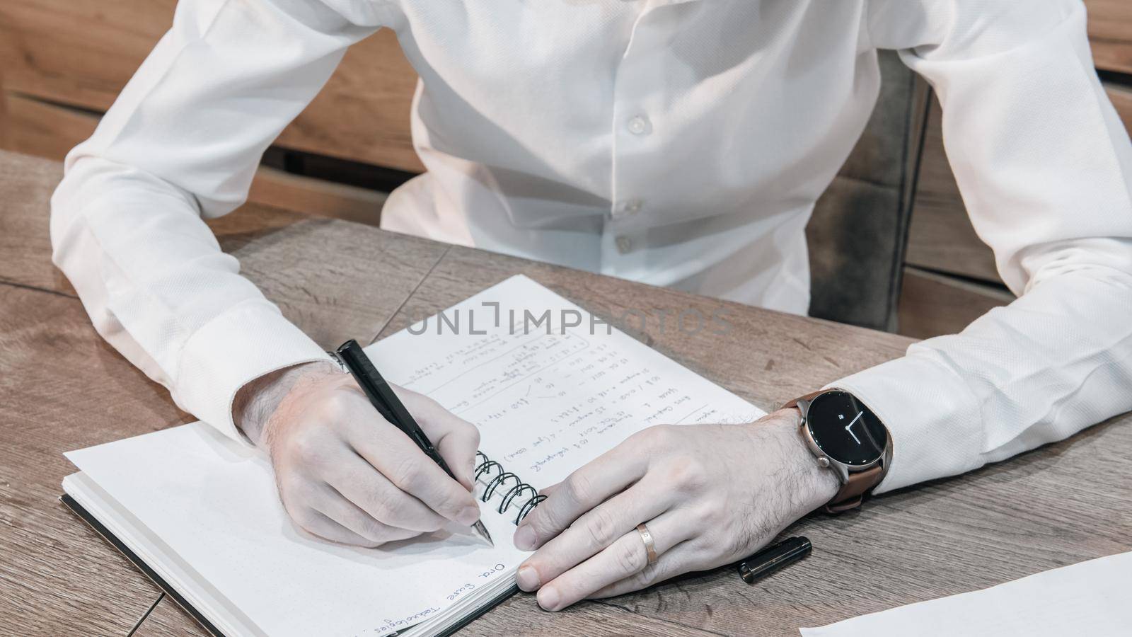 Businessman white shirt reading and signs documents by marynkin