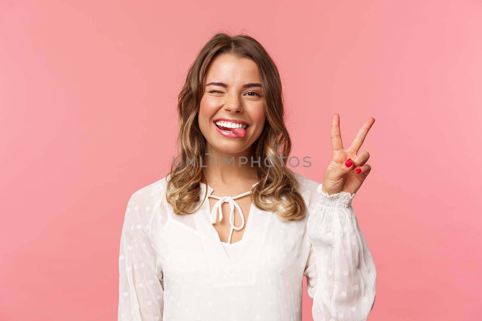 Close-up portrait of friendly joyful blond girl in white dress, sending positive vibes, smiling pleased and wink, stick tongue showing peace sign, looking kawaii over pink background by Benzoix