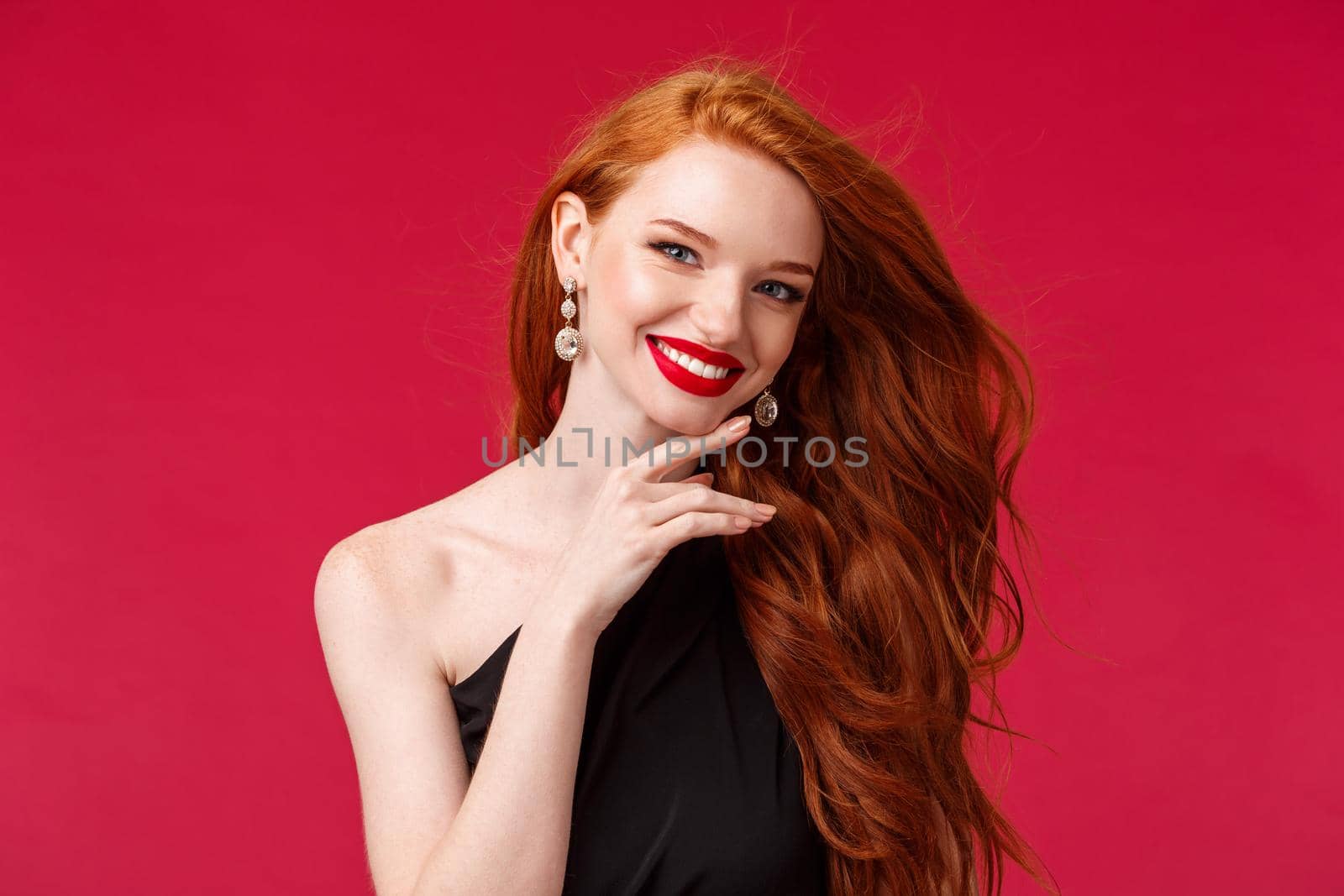 Makeup, beauty and women concept. Close-up portrait of feminine flirty redhead woman, true beauty, touching her jawline gently and smiling, looking camera delighted, red lipstick and black dress by Benzoix