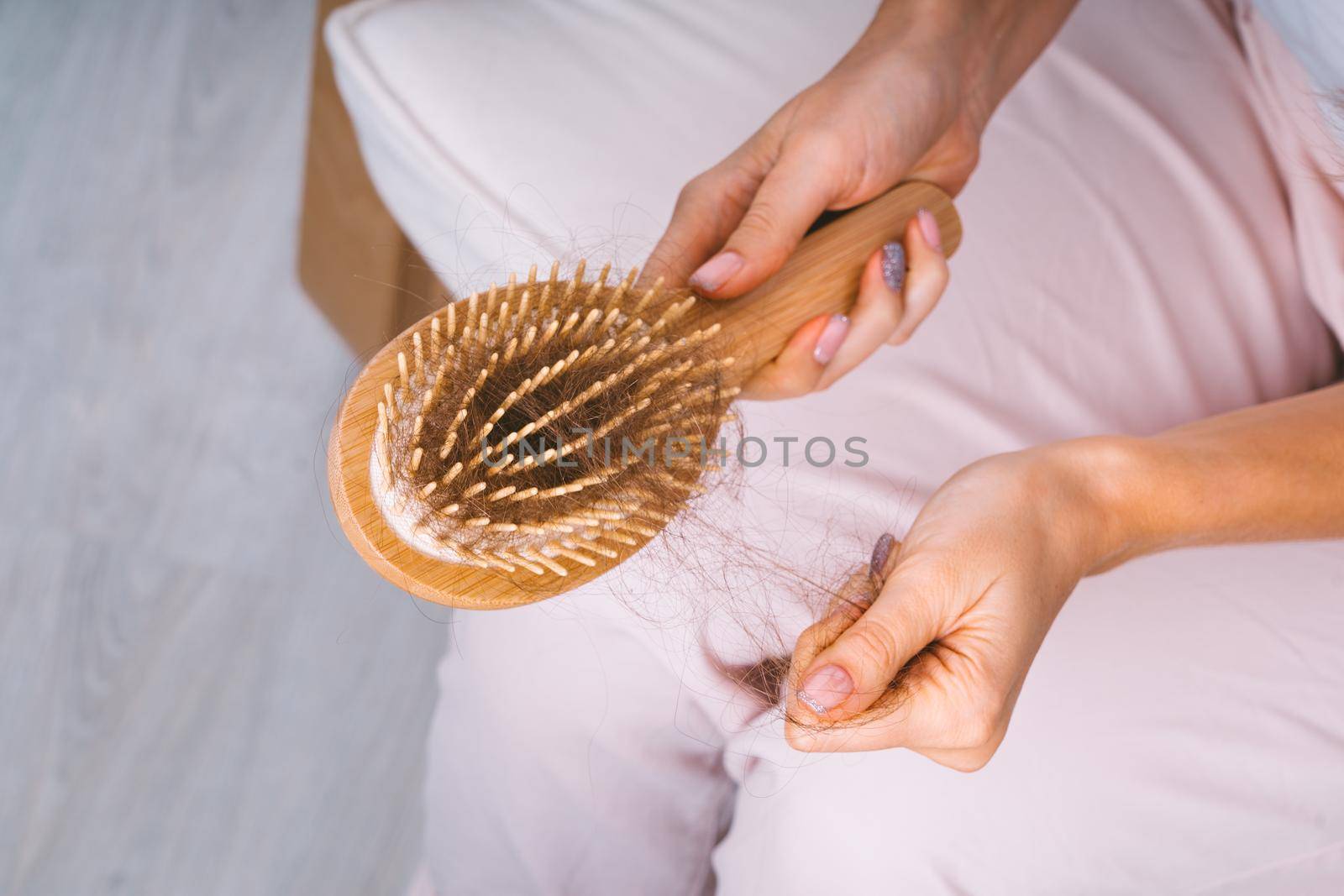 Woman taking her hair from hairbrush. Hair loss problem. Bad hair falling out by DariaKulkova