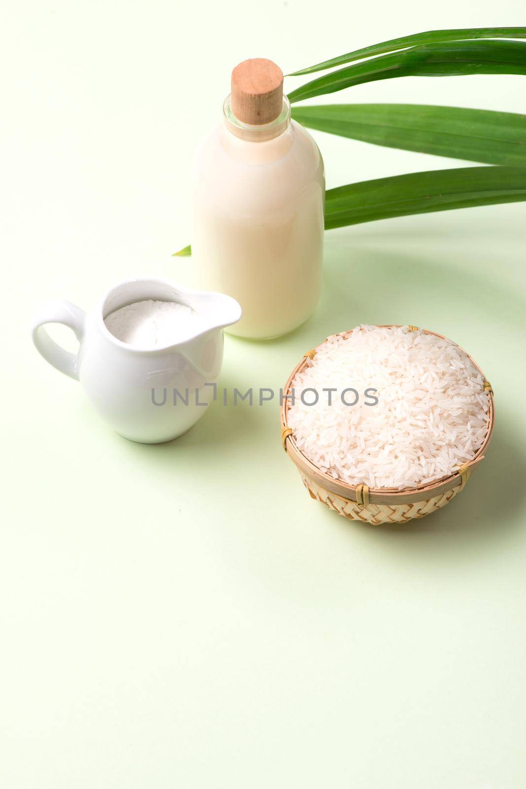 Milk and rice in bowl on light background. by makidotvn