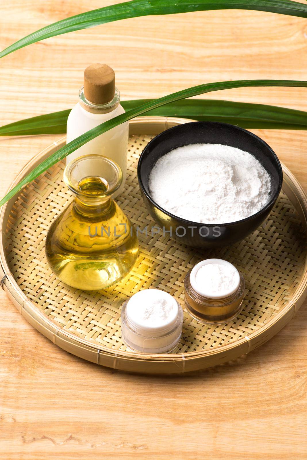 Rice bran oil extract and brown rice on wood table background.